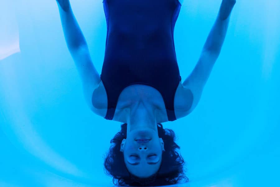 Woman floating on back in water of floatation tank in London